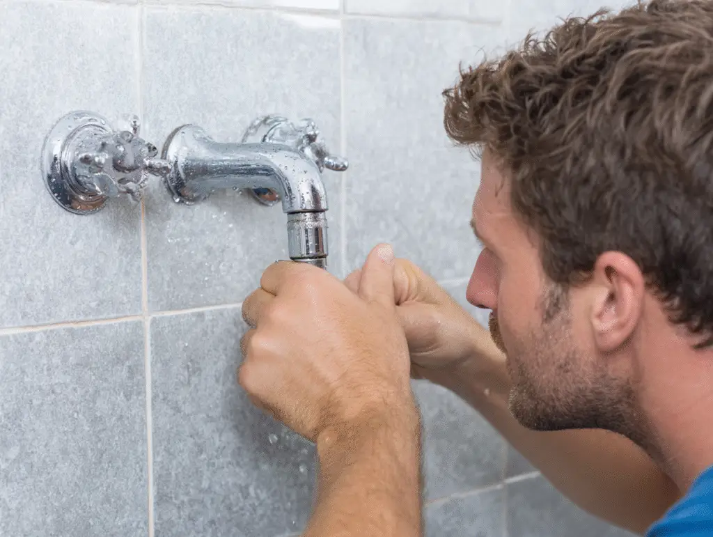 A plumbing engineer fixing a bathroom tab on a job