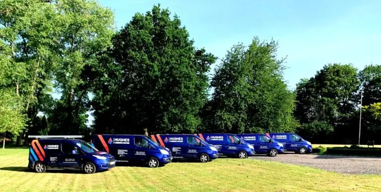 The Hughes plumbing and heating vans lined up together
